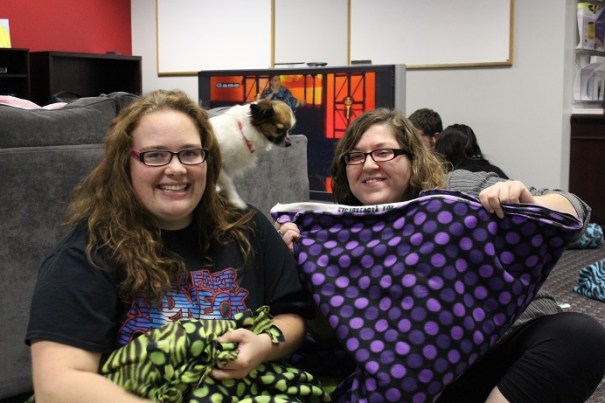 Brittany and Sierra showing off their handiwork (with a little help from the pooch perched on her shoulder)