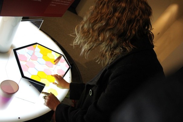 A guest assembles hexagons into a pattern.