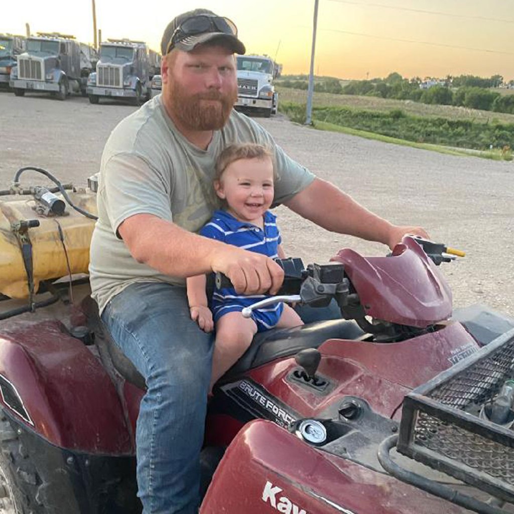Taylor Boyle gets ready to go for a ride with his little one.
