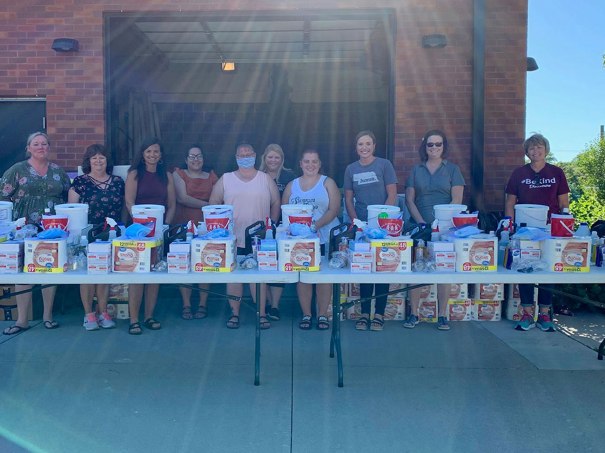 Columbus' Communities for Kids, the Community and Family Partnership, Columbus Public Schools, and other partners stand at attention, ready to hand out essential items.