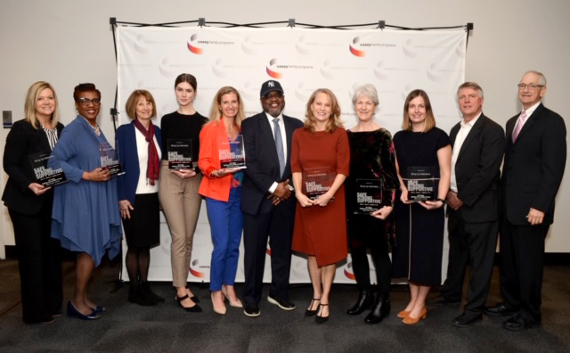 From left: Jennifer Skala (Nebraska Children and Families Foundation), CEO Dannette R. Smith (DHHS), Mary Jo Pankoke (Nebraska Children and Families Foundation), Rebecca Daugherty (DHHS), Michelle Paxton (Children’s Justice Clinic, Nebraska School of Law), Dr. William Bell (Casey Family Programs), First Lady Susanne Shore, Georgie Scurfield (Lift Up Sarpy), Emily Kluver (DHHS), Bill Stanton (Casey Family Programs), and David Mills (Chair of the Board of Trustees of Casey Family Programs).