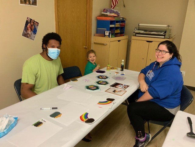 The family (above) enjoys developmentally-stimulating activities with their daughter. 