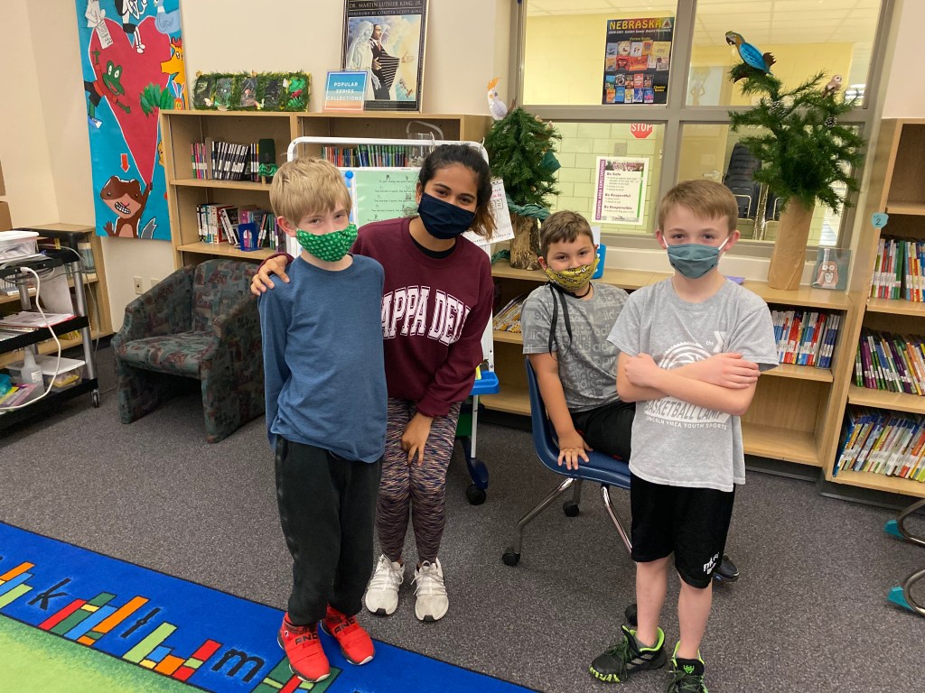 The power of collaboration: UNL Honors student, Sejal Soni, (middle) poses with her elementary-age afterschool students. Sejal has also worked as an ACTivate mentor for GIPS students. 
