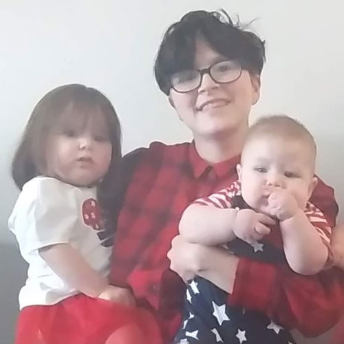 Ember, (above, middle) with their toddler and baby. 