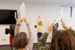 Meagan Heimbrecht, a junior from Lincoln and Brisa Rios, a sophomore from Scottsbluff, have everyone pretend to be pencils during a Winter Break 4-H STEM Challenge in Crete, Nebraska. UNL honors students work as winterns for 4-H/Extension winternships and the Galactic Quest activities. January 4, 2022 Photo by Craig Chandler / University Communication.
