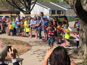 Here is everyone cutting the ribbon at the Stick Creek Kids' ceremony! 