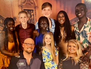 A family photo of biological and adopted children.