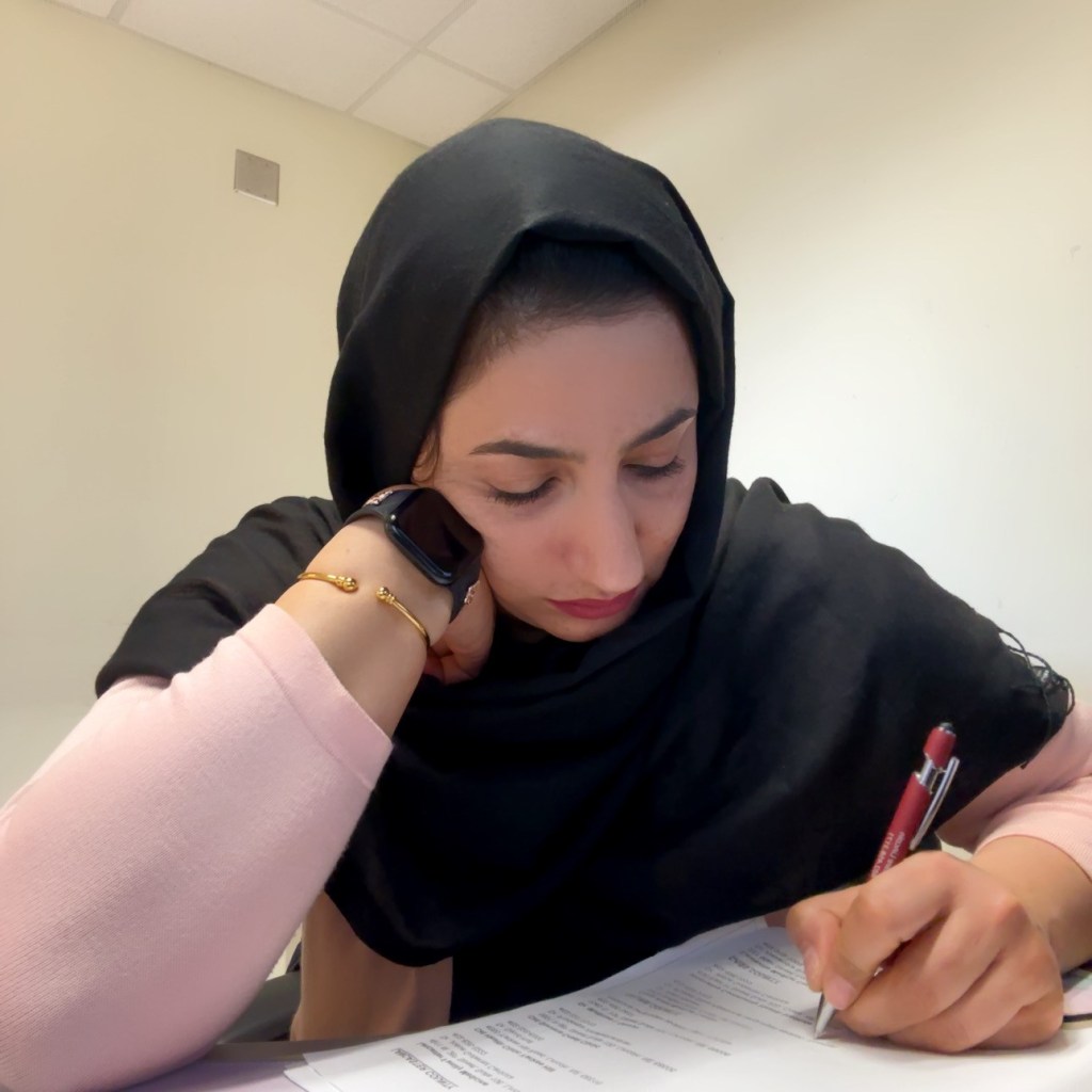 Woman translating book into Dari