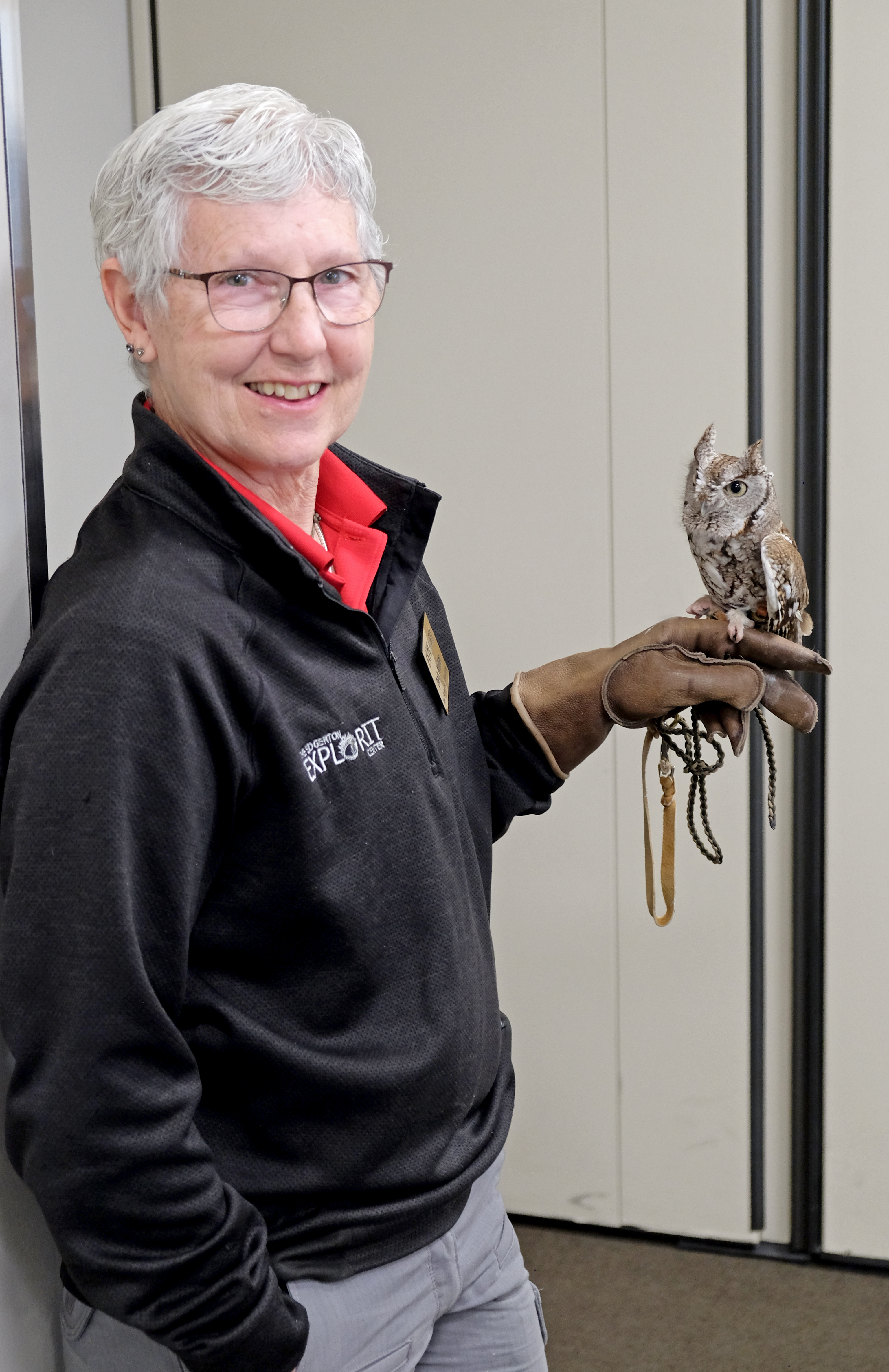 Woman holding a live owl.